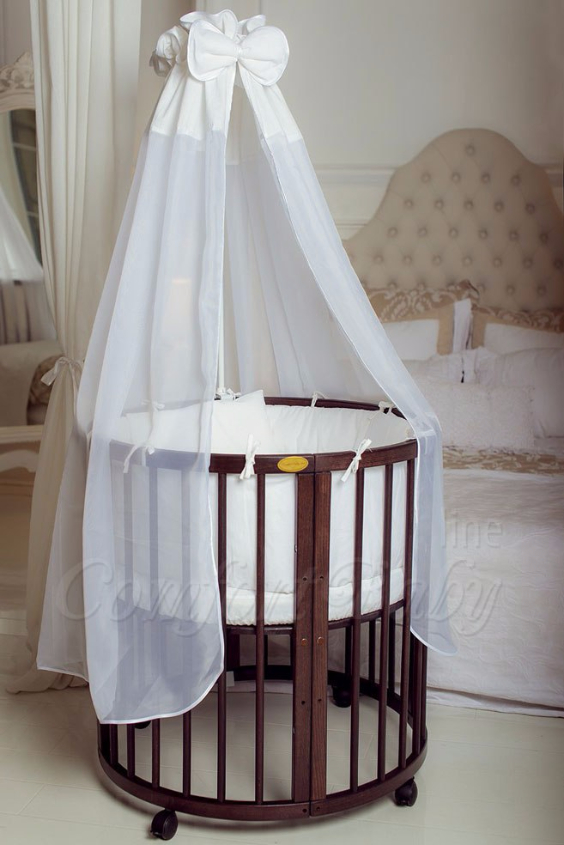 КРОВАТКА- ТРАНСФОРМЕР "COMFORT BABY" .Цена: 25 000 руб.  ХАРАКТЕРИСТИКИ:  возраст детей: 0-5 лет  габариты модели (Д х Ш х В): 1) колыбельки: 78*76*81 см  2) овальной кроватки: 128*76*81 cм  матрас приобретается отдельно.  максимальная нагрузка: 120 кг  Материал: изготавливается только из настоящего массива бука высшего сорта.  сборка: кровать в разобранном виде, простота сборки, инструкция по сборке на русском языке  продукция сертифицирована  производство: Россия  гарантия: 2 года   Дополнительные характеристики: 4 положения по высоте (расстояние положения дна от пола без колес: 1см, 12см, 37см, 57см; расстояние между отверстиями снизу-наверх: 12см, 15см, 20см.); 3 прутика - съемные.  КОНМПЛЕКТАЦИЯ:  1-я ступень - круглая кроватка  2-я ступень - овальная кроватка  3-я ступень - диванчик  4-я ступень - манеж  5-я и 6-я ступени - 2 кресла и столик  7-я ступень - пеленальный столик  ДОПОЛНИТЕЛЬНЫЕ ОПЦИИ:  Комплект постельный "Classic" +6950 руб.  Комплект постельный "Colorit" + 11990 руб.  Фирменный держатель для балдахина +790 руб.  Комплект цельных матрасов " Холкон"/ "Кокос" (круглый+овальный) +8490 руб  Маятник "ComfortBaby Pendulum" 2 в 1+6990 руб.