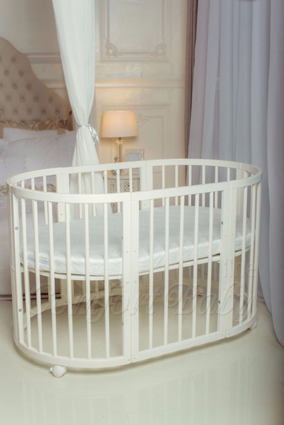 КРОВАТКА- ТРАНСФОРМЕР "COMFORT BABY" .Цена: 25 000 руб.  ХАРАКТЕРИСТИКИ:  возраст детей: 0-5 лет  габариты модели (Д х Ш х В): 1) колыбельки: 78*76*81 см  2) овальной кроватки: 128*76*81 cм  матрас приобретается отдельно.  максимальная нагрузка: 120 кг  Материал: изготавливается только из настоящего массива бука высшего сорта.  сборка: кровать в разобранном виде, простота сборки, инструкция по сборке на русском языке  продукция сертифицирована  производство: Россия  гарантия: 2 года   Дополнительные характеристики: 4 положения по высоте (расстояние положения дна от пола без колес: 1см, 12см, 37см, 57см; расстояние между отверстиями снизу-наверх: 12см, 15см, 20см.); 3 прутика - съемные.  КОНМПЛЕКТАЦИЯ:  1-я ступень - круглая кроватка  2-я ступень - овальная кроватка  3-я ступень - диванчик  4-я ступень - манеж  5-я и 6-я ступени - 2 кресла и столик  7-я ступень - пеленальный столик  ДОПОЛНИТЕЛЬНЫЕ ОПЦИИ:  Комплект постельный "Classic" +6950 руб.  Комплект постельный "Colorit" + 11990 руб.  Фирменный держатель для балдахина +790 руб.  Комплект цельных матрасов " Холкон"/ "Кокос" (круглый+овальный) +8490 руб  Маятник "ComfortBaby Pendulum" 2 в 1+6990 руб.